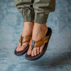 Man wearing Country Maddox tan leather slippers with a relaxed outfit.